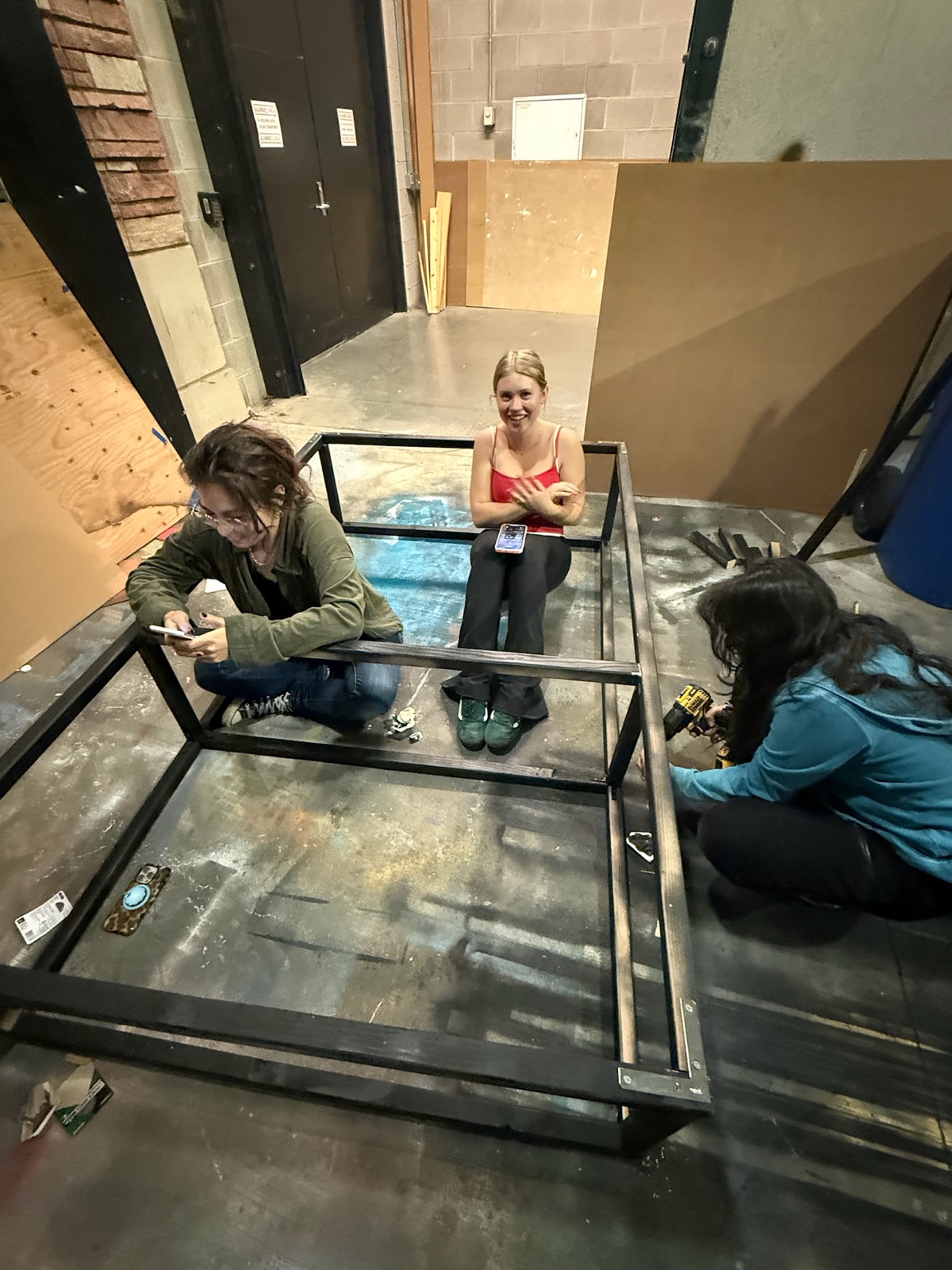 Team members assembling and testing the exhibit frame together